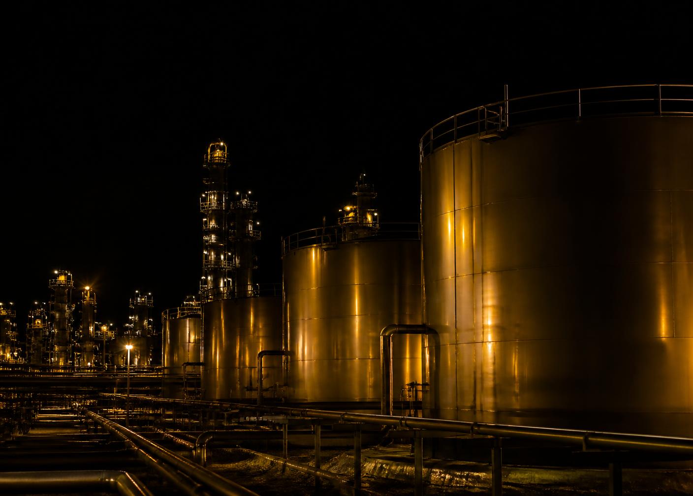 Chemical storage tank farm lit at night